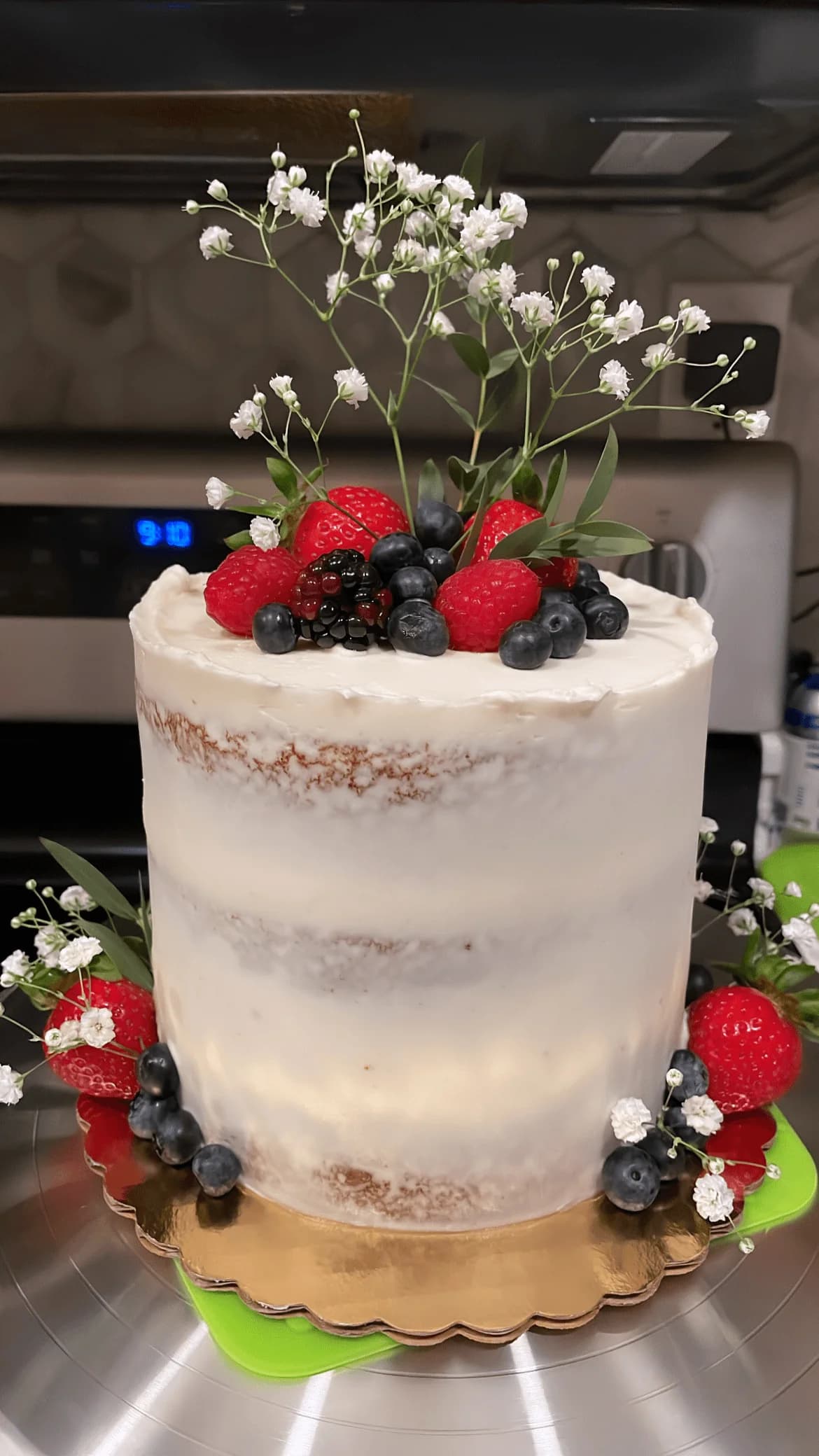 Rustic naked cake with fresh berries and baby's breath
