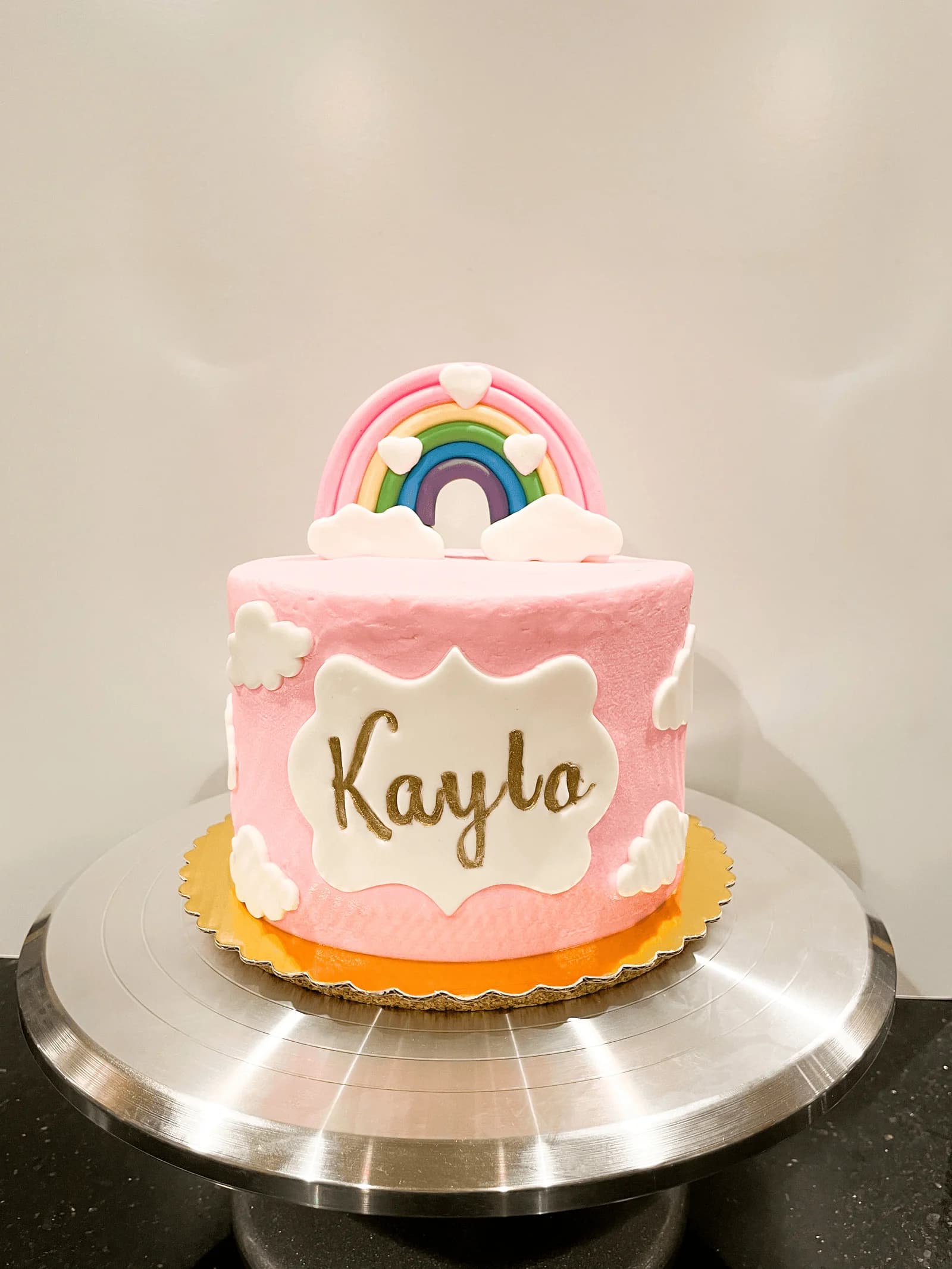 Rainbow birthday cake with clouds for first birthday