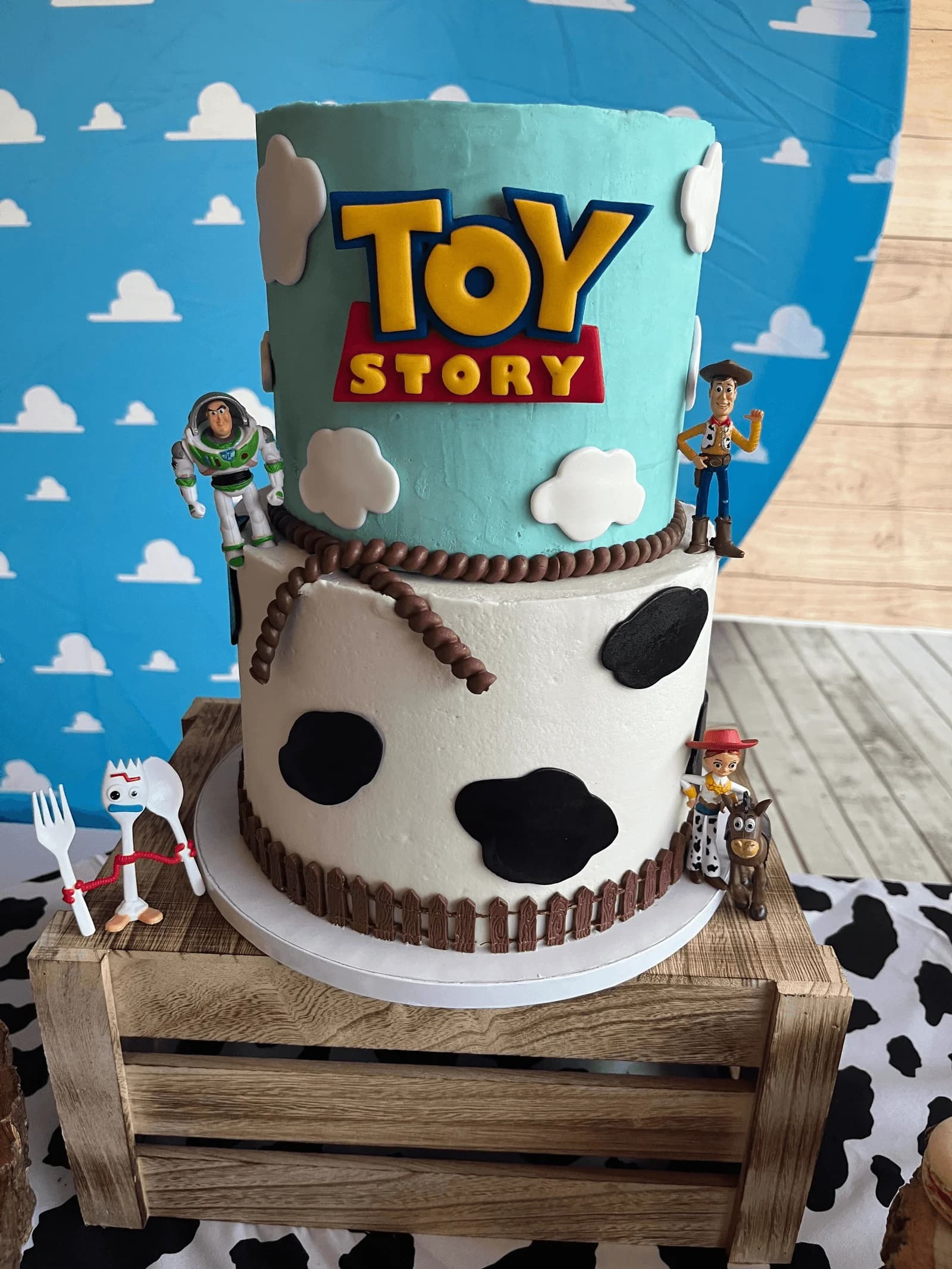 Two-tier Toy Story birthday cake with Woody and Buzz Lightyear decorations