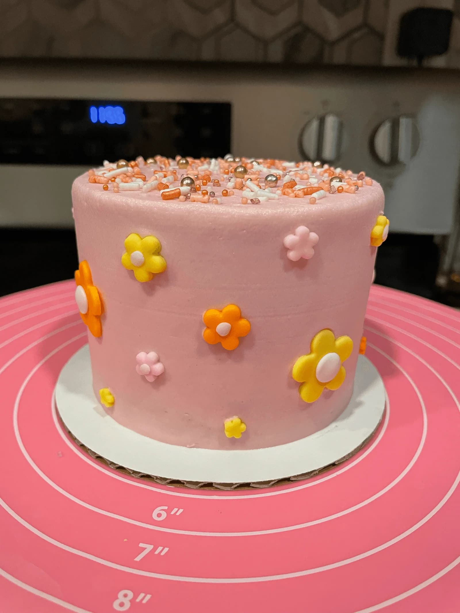 Pink daisy birthday cake with sprinkles