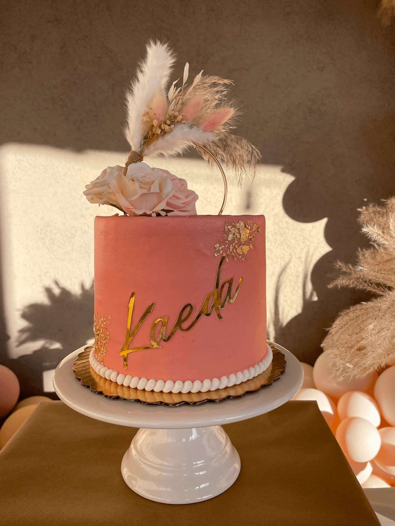 Boho style birthday cake with pampas grass and roses