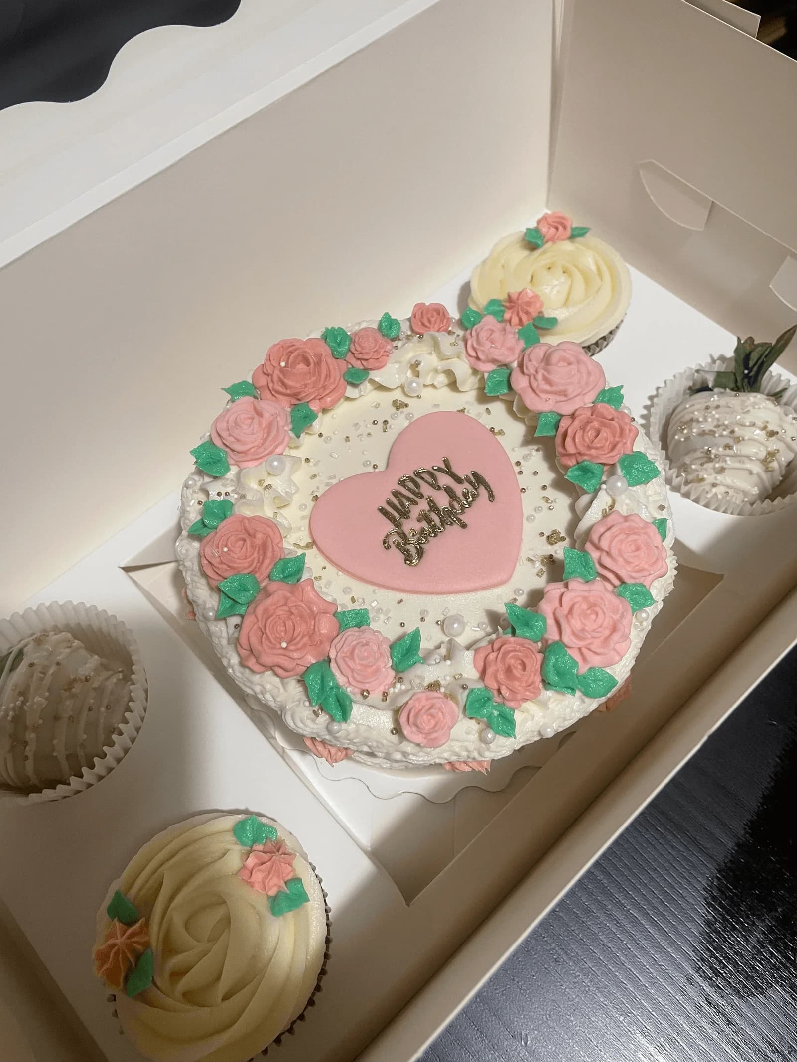Heart-shaped birthday cake with pink roses