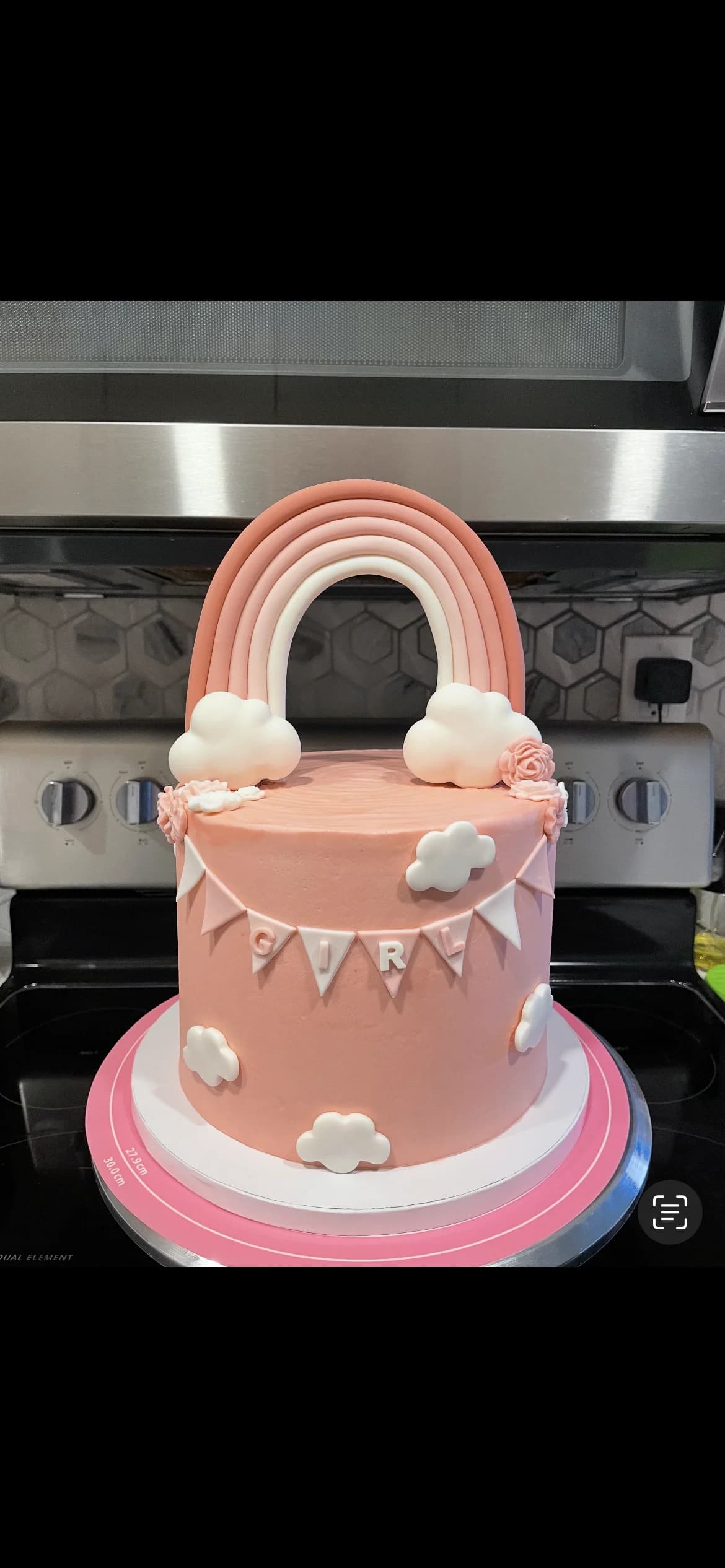 Pink rainbow and clouds birthday cake with fondant banner bunting