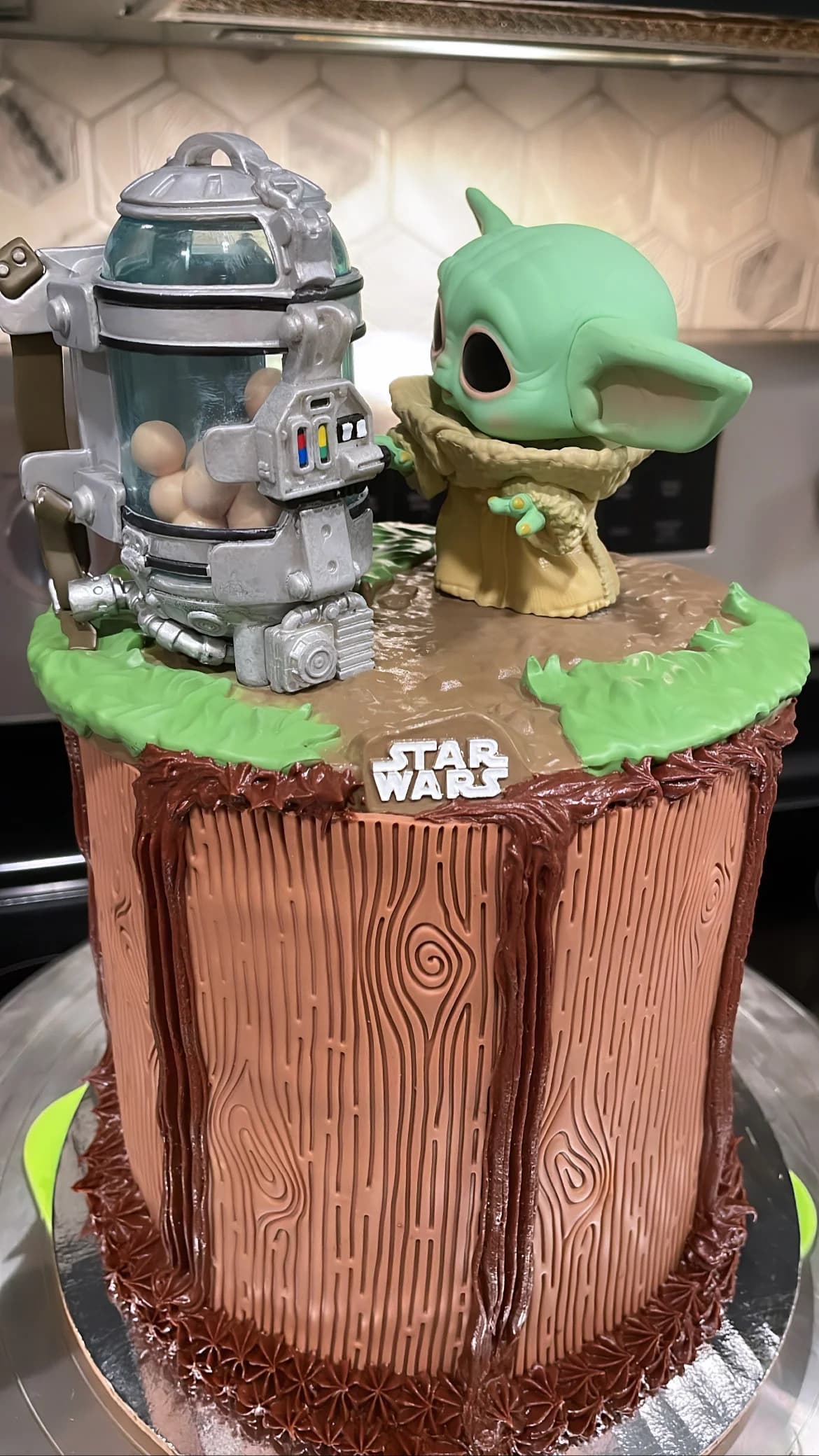 Star Wars Baby Yoda birthday cake with wood grain chocolate frosting and Grogu figurine topper