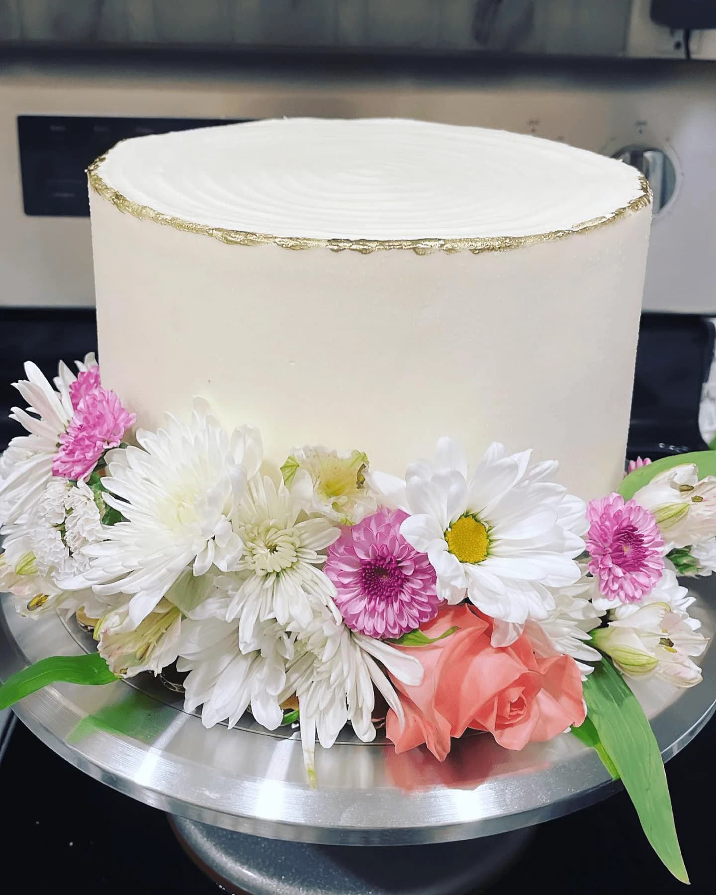Elegant white wedding cake with fresh flower arrangement