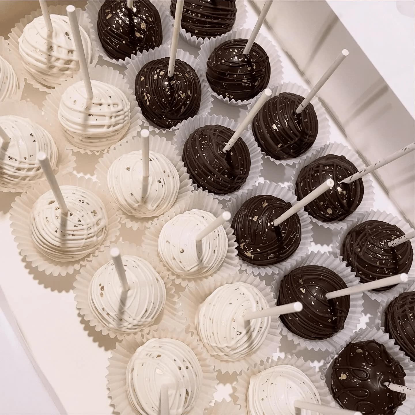 Black and white cake pops with gold sprinkles