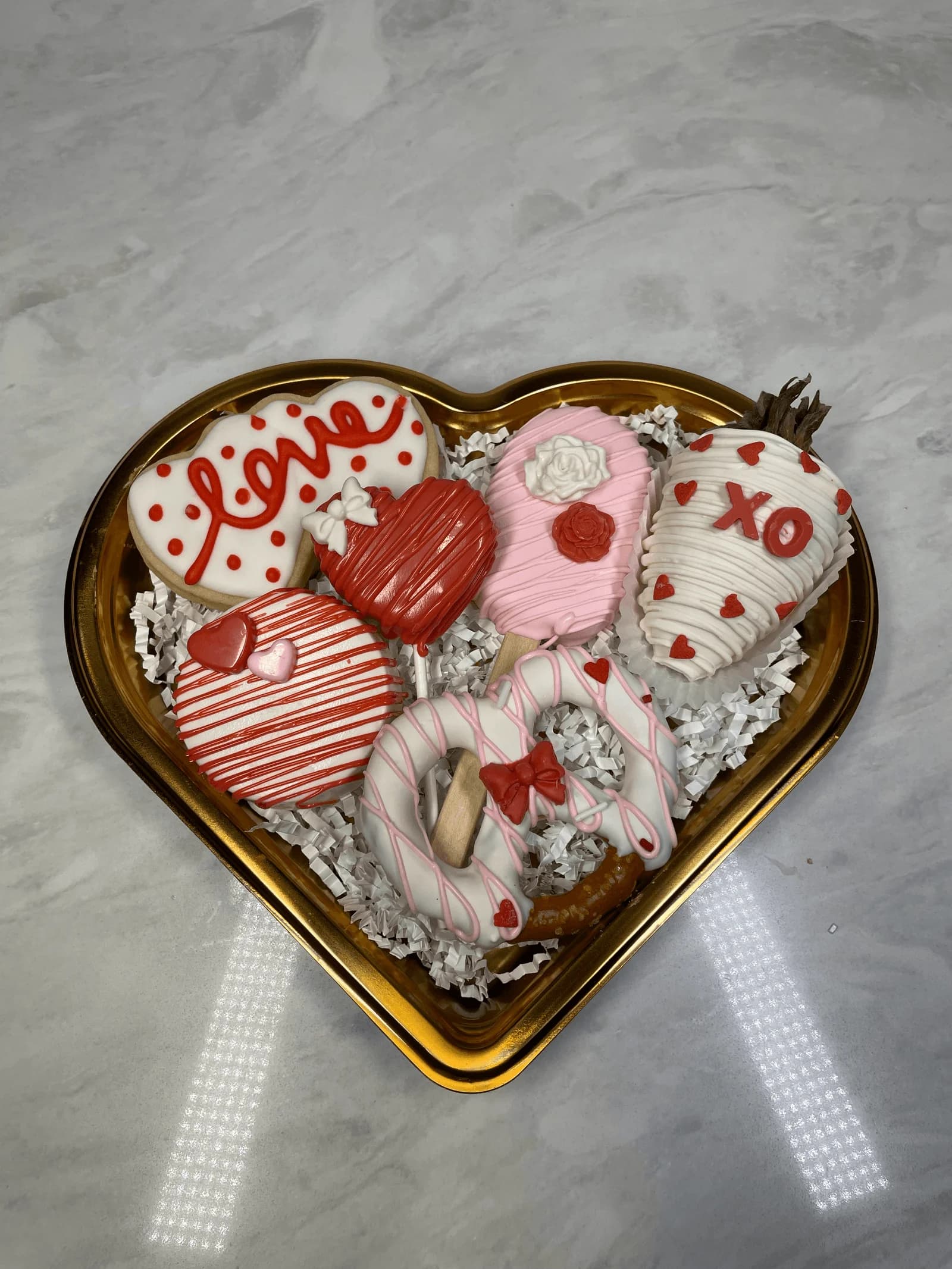 Valentine's heart box with chocolate covered strawberries and treats