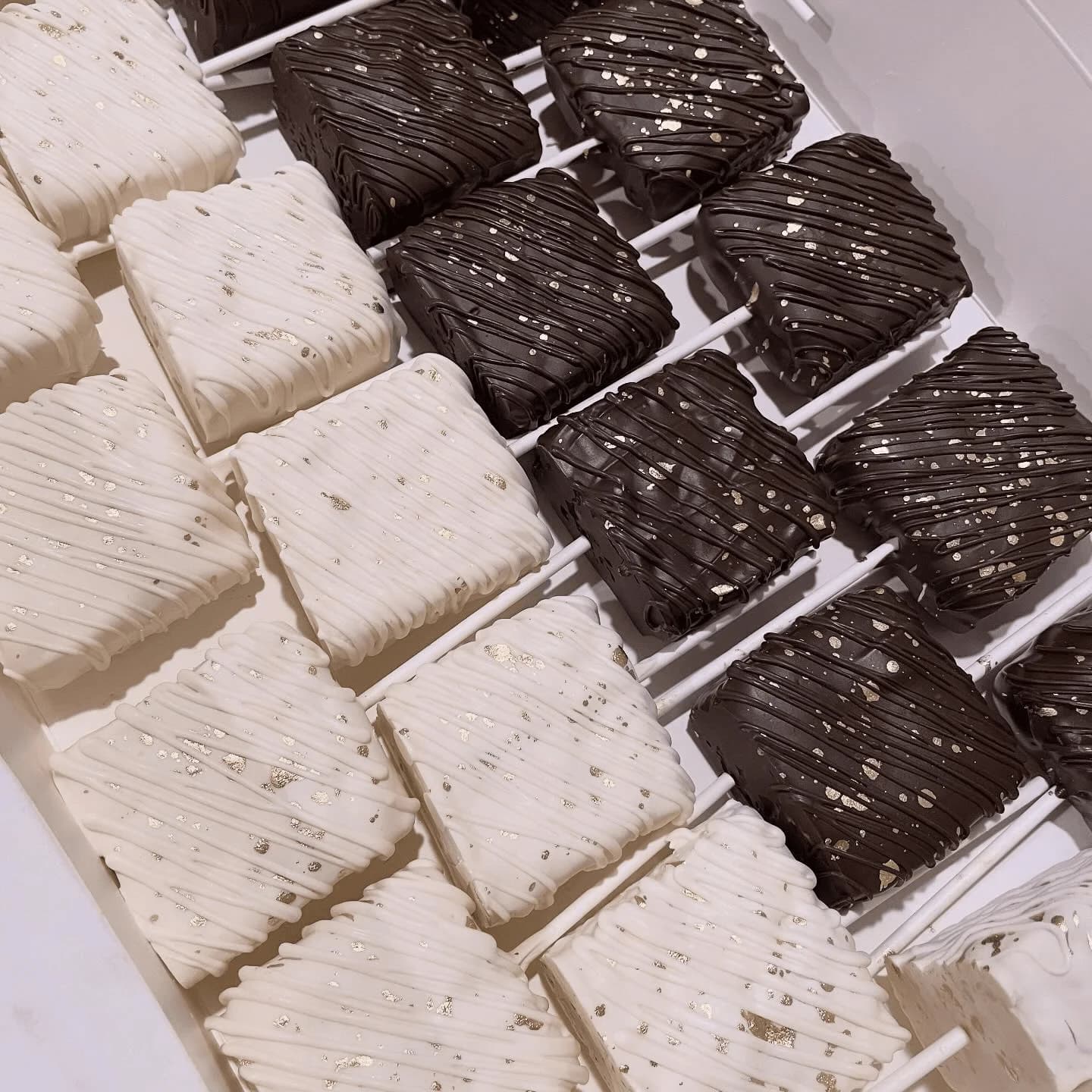 Chocolate dipped Rice Krispie treats in milk and white chocolate