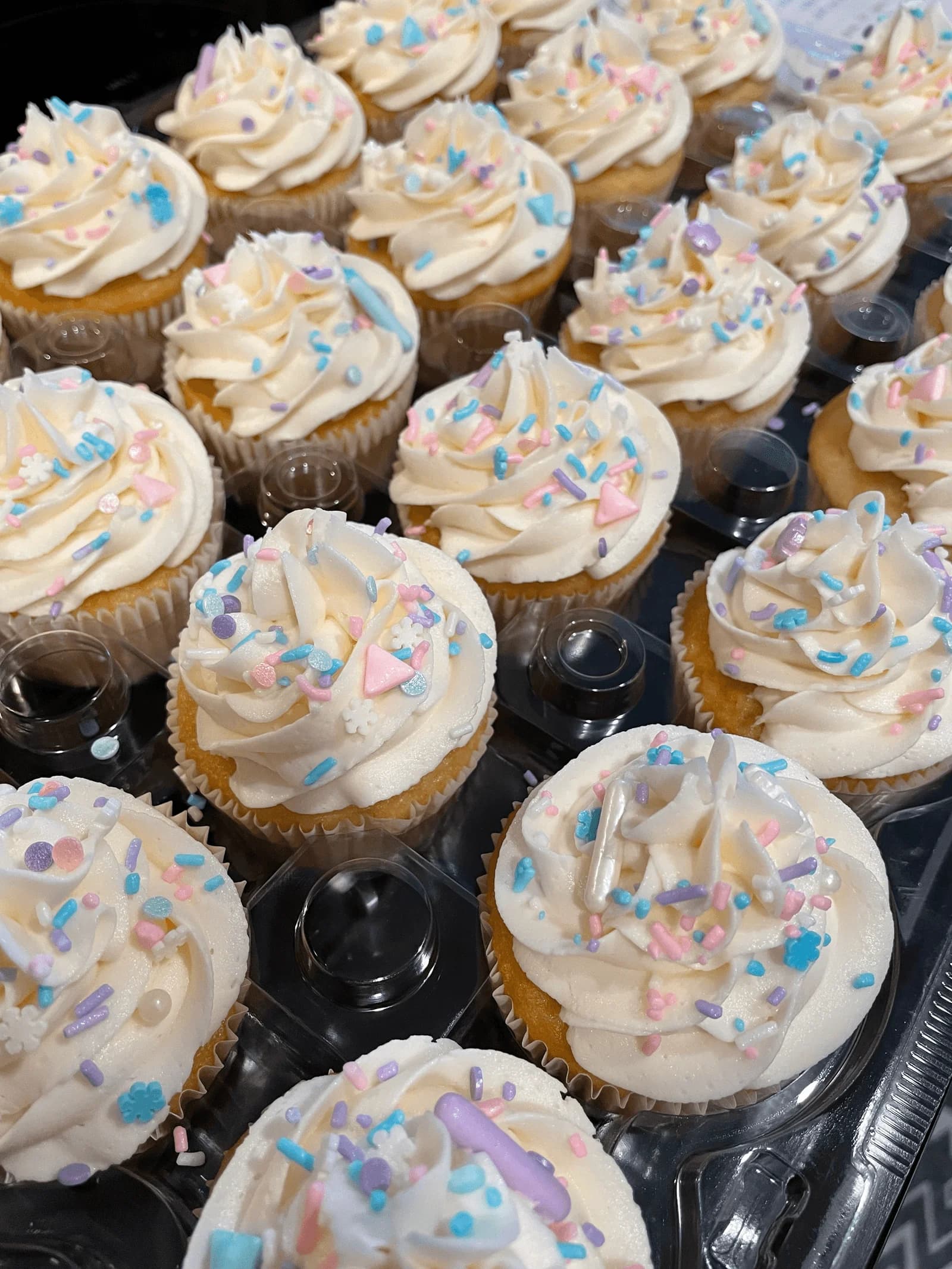 White vanilla cupcakes with blue sprinkles for baby shower