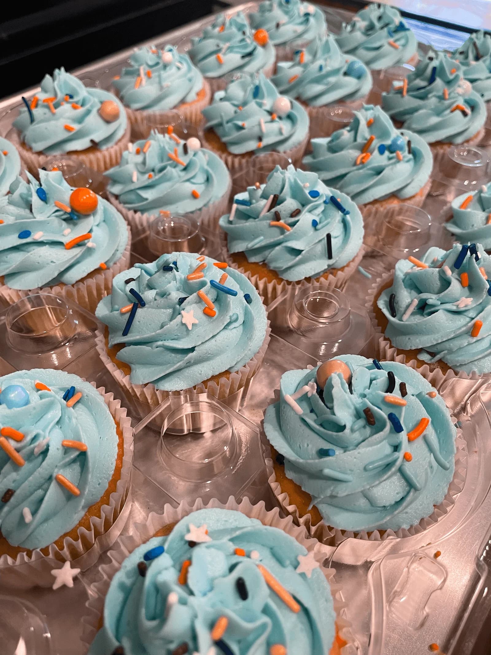 Blue buttercream cupcakes with colorful sprinkles