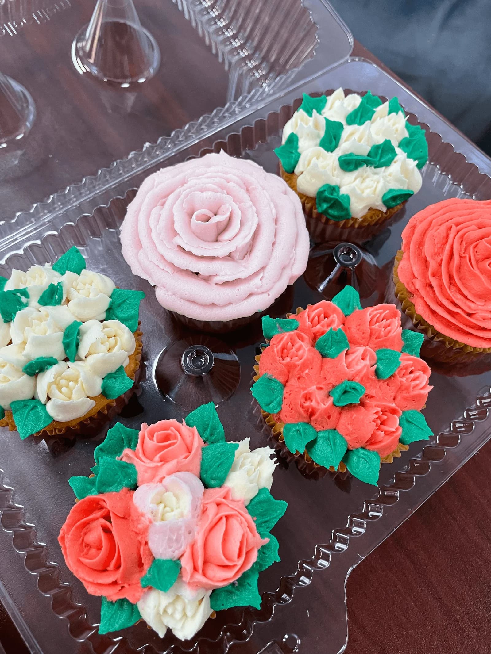 Floral buttercream cupcakes with piped roses and leaves