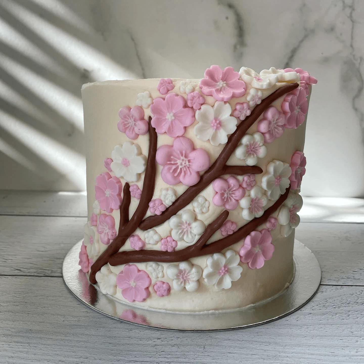 Custom cherry blossom cake with pink and white fondant flowers