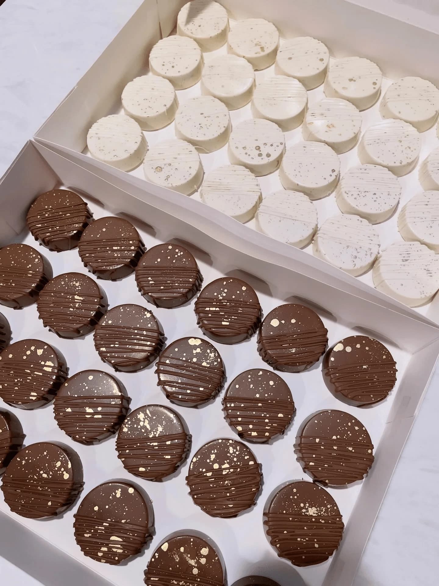 Chocolate covered cake discs with gold drizzle